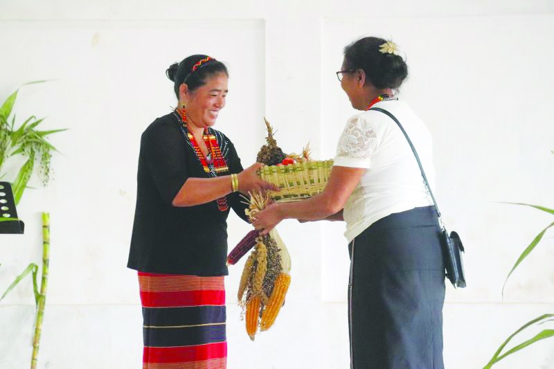 Two women farmers – one from Chakhesang and the other from Pochury community exchange seeds during the Biodiversity Festival held at Shatuza village under Weziho Block of Phek district on September 20. (Photo Courtesy: NEN)
